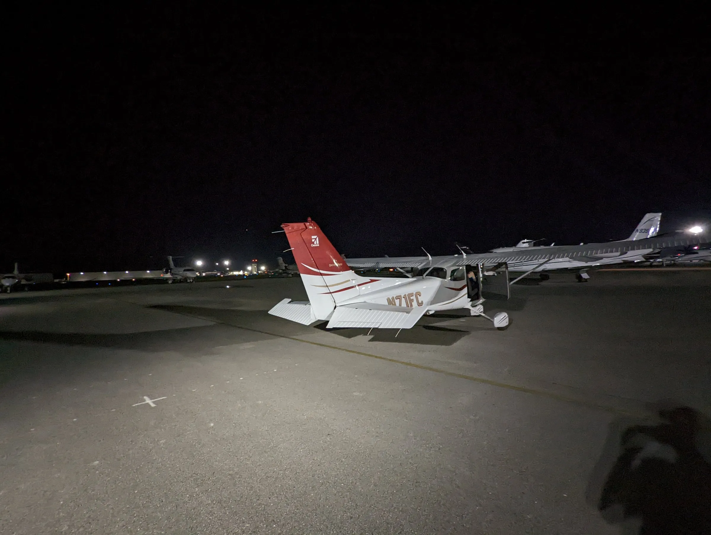 Naples Flying Club Cessna 172R N71FC parked on the ramp at night