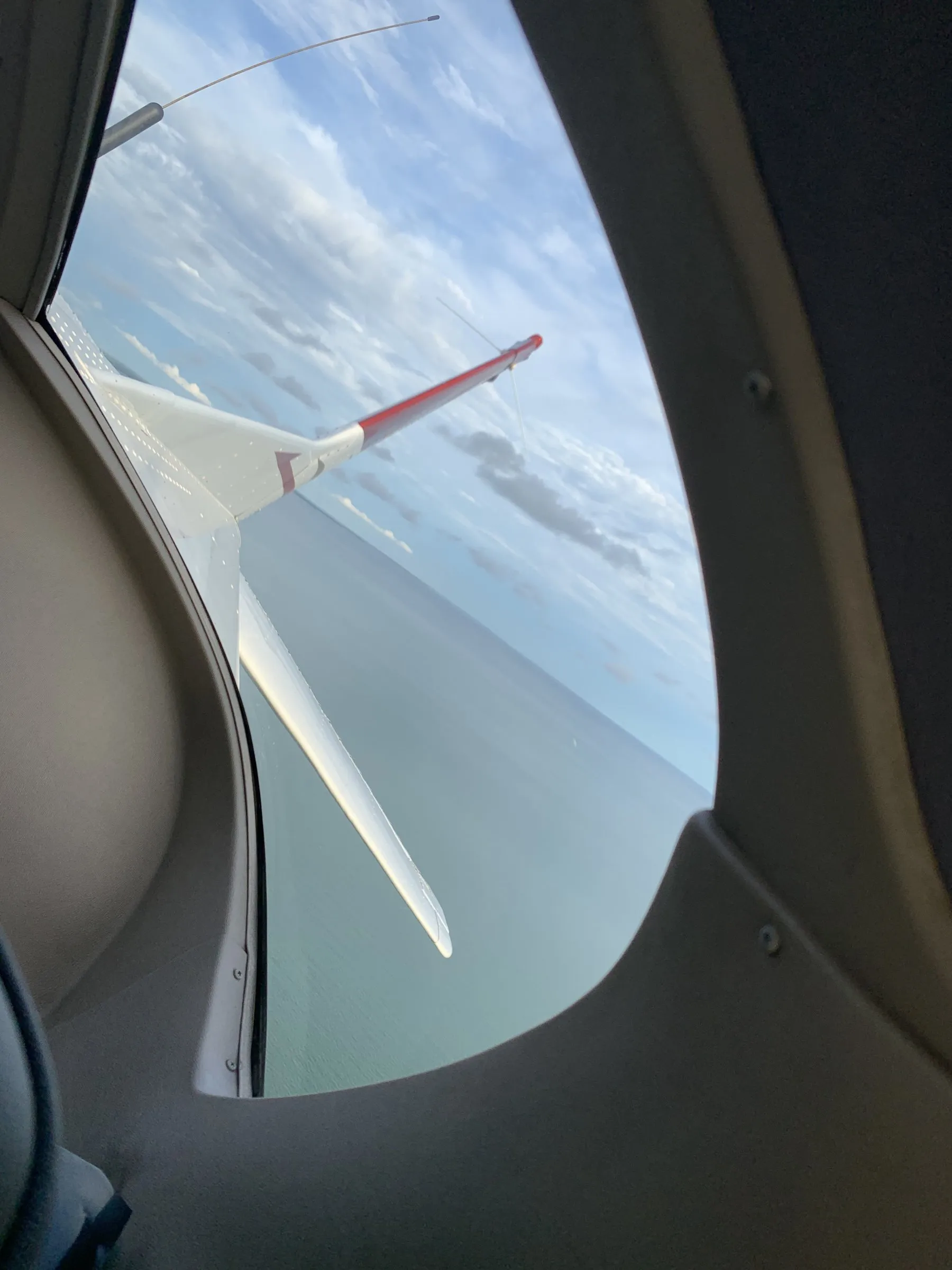 Wing + red wingtip through cabin window