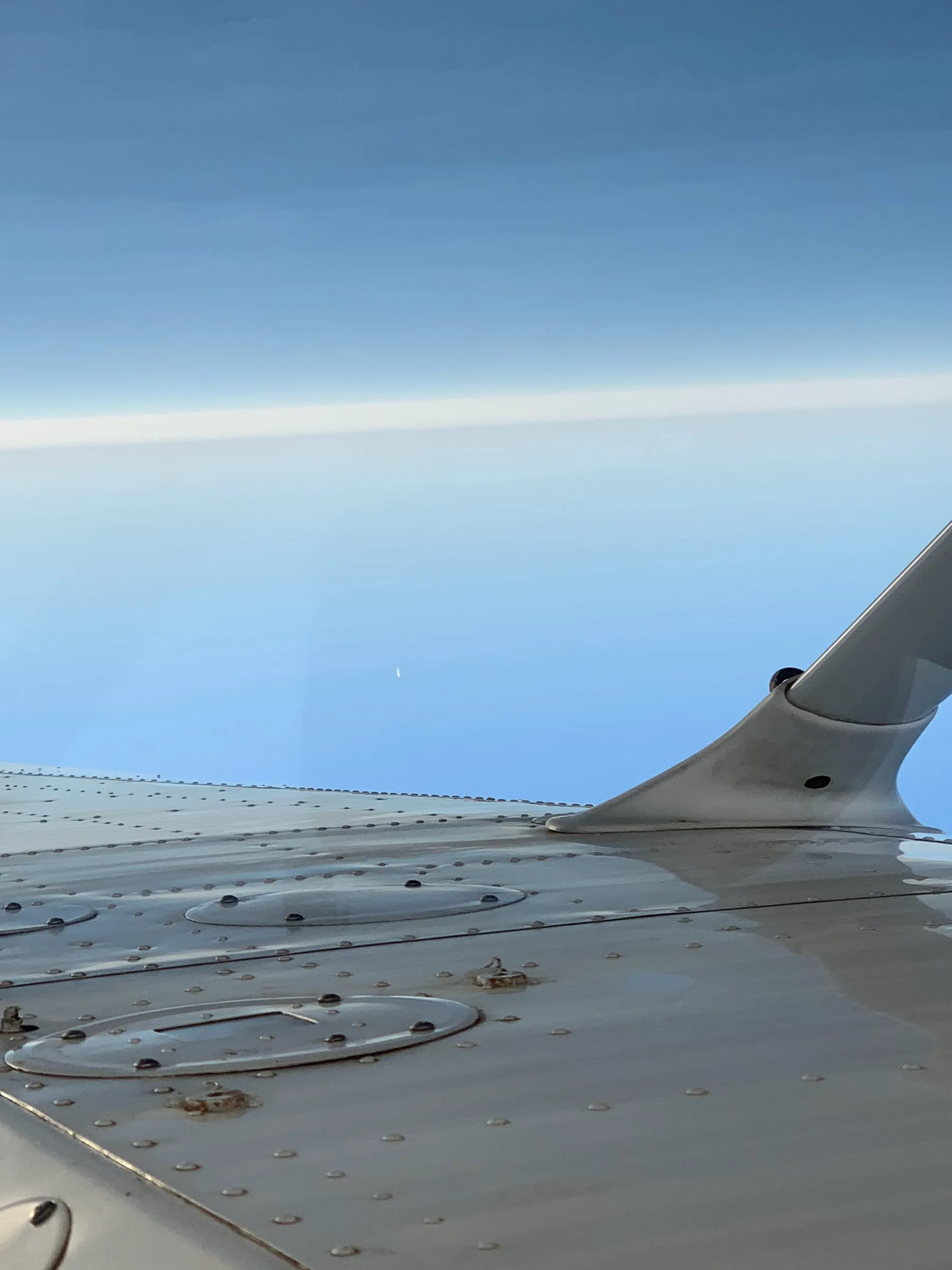 Wing root + rivets against sky
